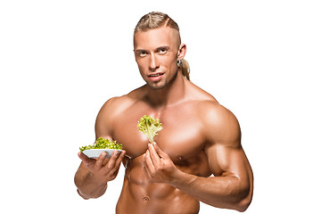 Image showing Shaped and healthy body man holding a fresh lettuce,  isolated on white background