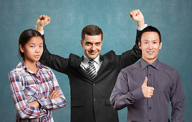 Image showing Asian team and businessman with hands up