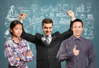 Image showing Asian team and businessman with hands up