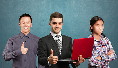 Image showing Asian team and male in suit with laptop in his hands