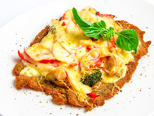 Image showing Crispy veal schnitzel with cheese, tomatoes, peppers, broccoli and mushrooms