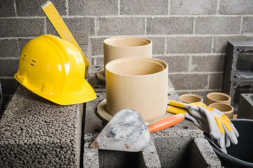 Image showing Parts and tools for the construction of modular ceramic chimney in the house