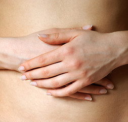 Image showing Hands on a belly