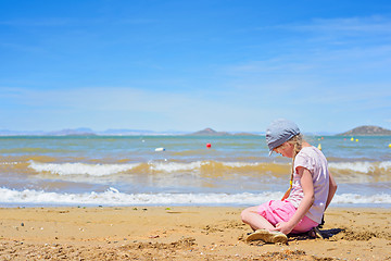 Image showing Little girl playing on the beach