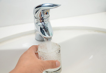 Image showing Filling glass of water  