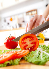 Image showing Woman\'s hands cutting tomato