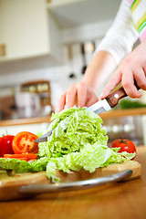 Image showing Woman\'s hands cutting vegetables