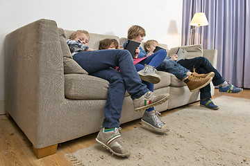 Image showing Bored children gaming on a couch