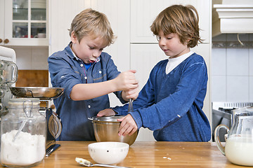 Image showing Boys mixing dough in a bowl using a whisk