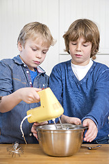 Image showing Boys mixing dough in a bowl