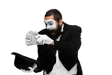 Image showing mime as a businessman laying dollars in hat