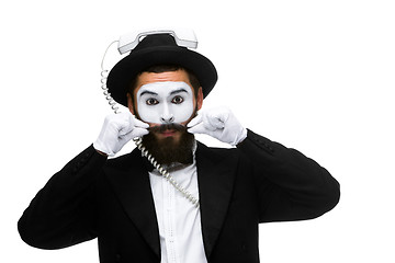 Image showing man in the image mime holding a handset. 