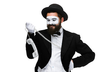 Image showing man in the image mime holding a handset. 