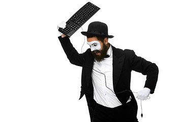 Image showing Angry mime as a businessman is destroying  keyboard