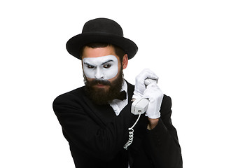 Image showing man in the image mime holding a handset. 