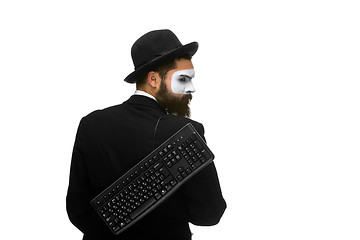 Image showing mime as a businessman holdinga keyboard behind