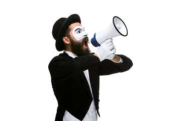 Image showing Man with a face mime screaming into megaphone 
