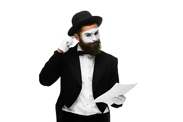 Image showing pensive mime as a businessman reading the list of paper 