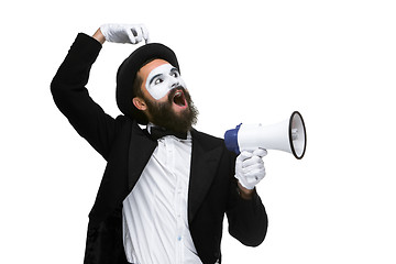 Image showing Man with a face mime screaming into megaphone 