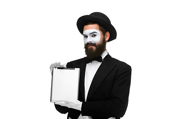 Image showing Man with a face mime working on  laptop