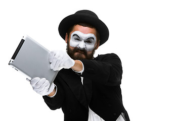 Image showing mime as a businessman throws computer in rage.