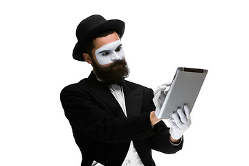 Image showing Man with a face mime working ona laptop 