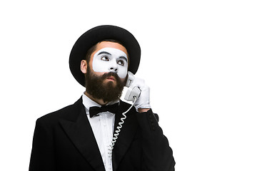 Image showing man in the image mime holding a handset. 