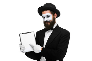 Image showing Man with a face mime working on laptop 