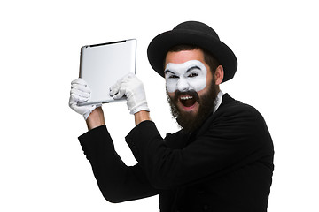 Image showing mime as a businessman throws computer in rage.