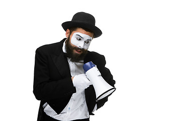 Image showing Man with a face mime screaming into megaphone 