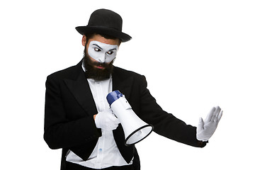 Image showing Man with a face mime screaming into megaphone 