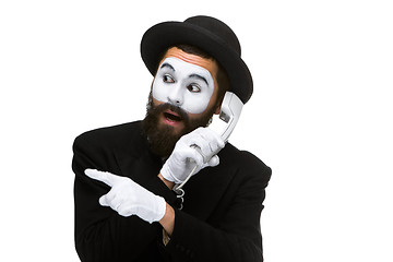 Image showing man in the image mime holding a handset. 