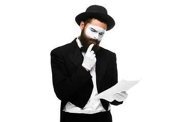 Image showing pensive mime as a businessman reading the list of paper 