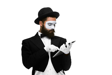 Image showing Man with a face mime working on laptop 