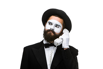 Image showing man in the image mime holding a handset. 