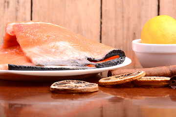 Image showing Slice of red fish salmon with fruits and cinnamon