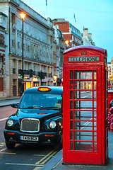 Image showing Famous red telephone booth and taxi cab in London