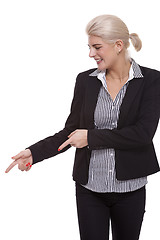 Image showing Businesswoman Pointing Up While Looking at Camera