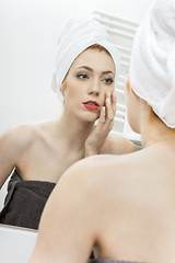Image showing Woman From Shower Looking her Face at the Mirror