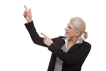 Image showing Businesswoman Pointing Up While Looking at Camera