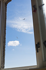 Image showing Blue cloudy sky in window