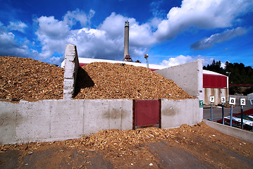 Image showing bio power plant with storage of wooden fuel against blue sky