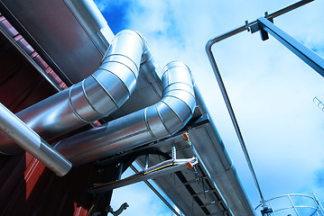 Image showing Industrial zone, Steel pipelines and valves against blue sky