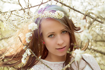 Image showing Portrait of cheerful fashionable woman in spring blooming tree