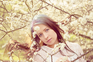 Image showing Portrait of cheerful fashionable woman in spring blooming tree