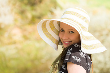 Image showing Cheerful fashionable woman in stylish hat and frock posing