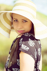 Image showing Cheerful fashionable woman in stylish hat and frock posing