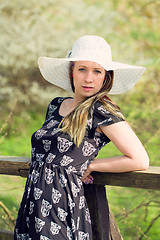 Image showing Cheerful fashionable woman in stylish hat and frock posing