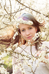 Image showing Portrait of cheerful fashionable woman in spring blooming tree