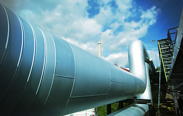 Image showing Industrial zone, Steel pipelines and valves against blue sky